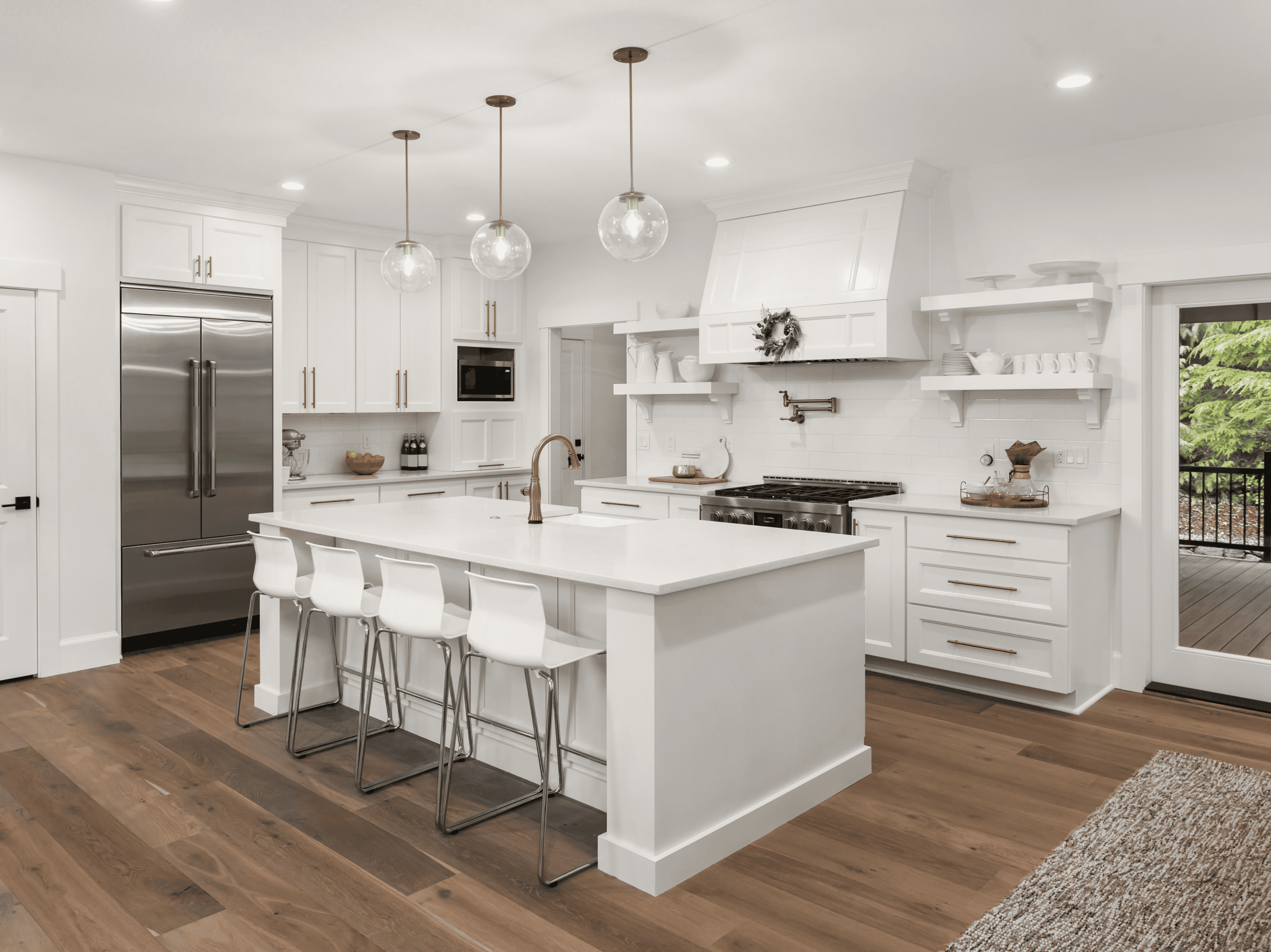 Bright modern kitchen with white cabinets, island, and pendant lighting, perfect for family cooking.