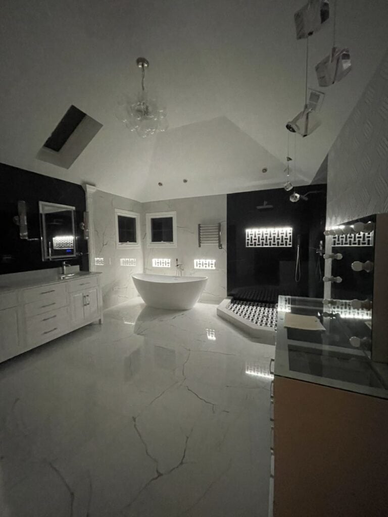 Modern luxury bathroom with freestanding tub and sleek fixtures.