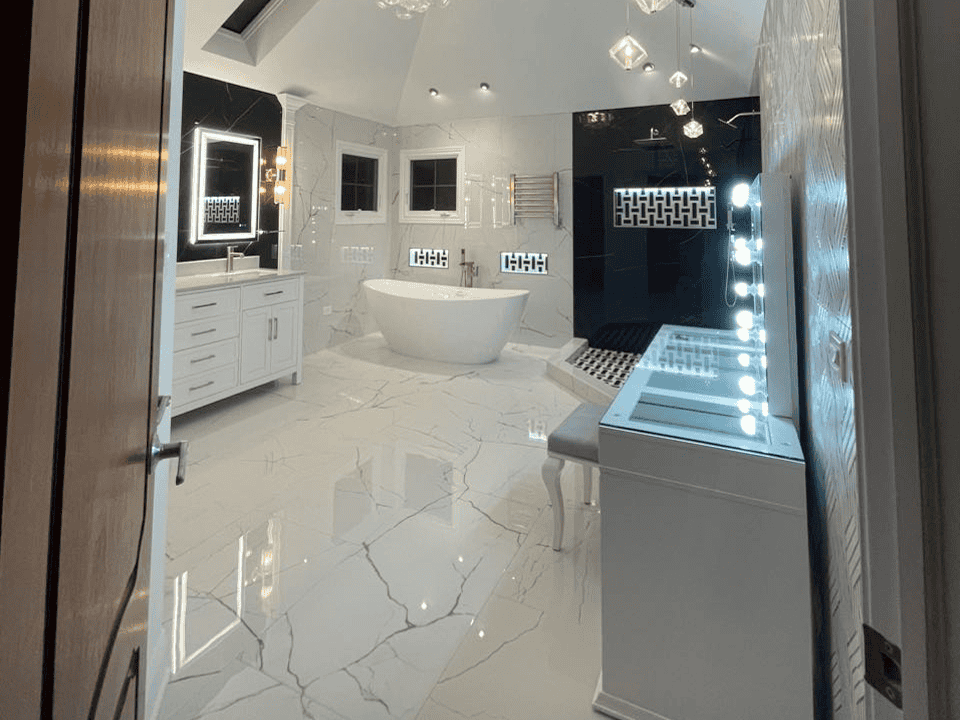 Modern luxury bathroom with freestanding tub, marble floors, and stylish lighting fixtures.