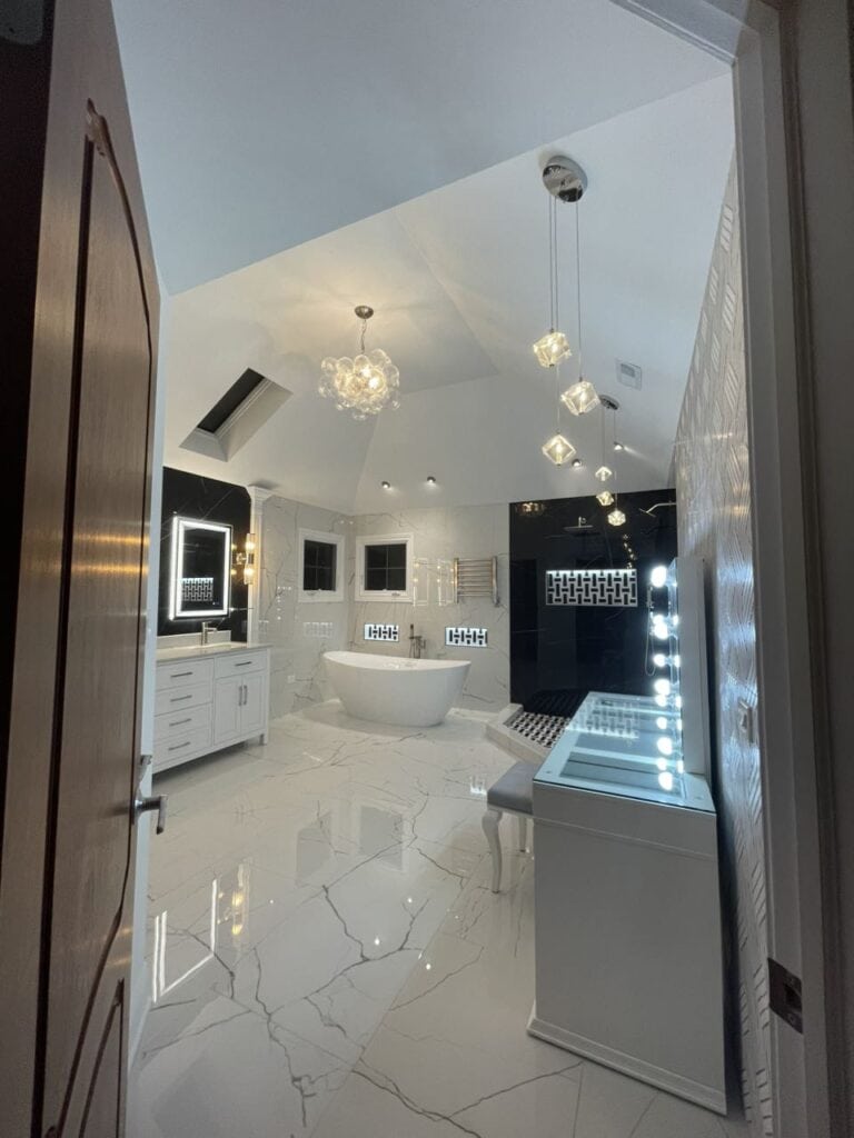 Elegant modern bathroom with freestanding tub and stylish lighting fixtures.