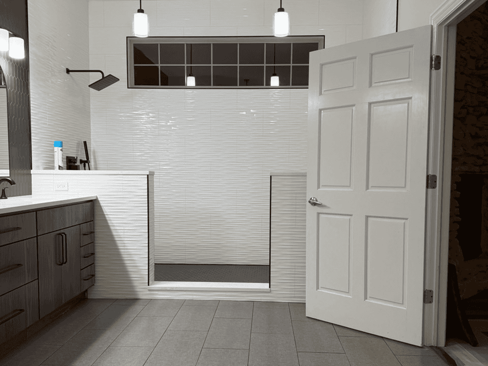 Contemporary bathroom with walk-in shower, white textured tiles, and wooden vanity.